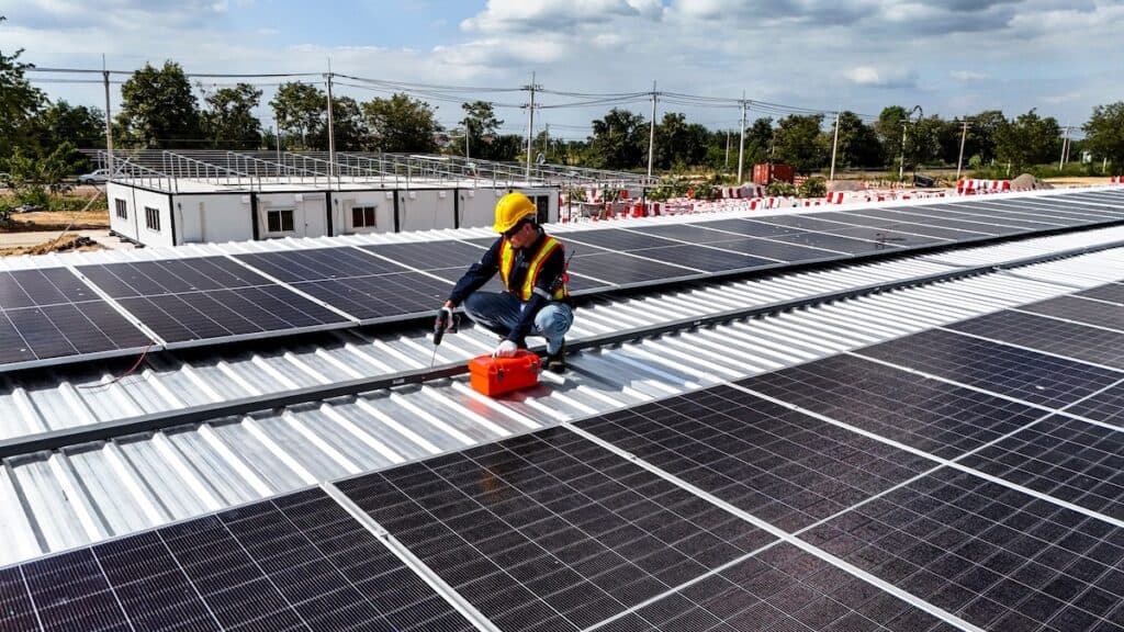 Workers installing and inspecting solar panels on a rooftop in a sunny environment, highlighting renewable energy, sustainability, and efficient use of modern technology in solar power systems.