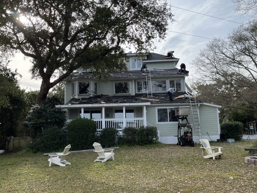 team working on repairing shingles roof shingle roof replacement