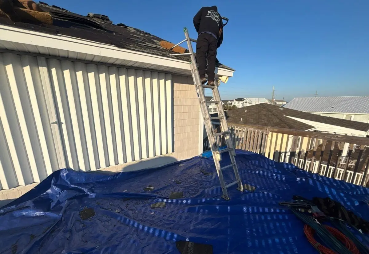 roof repair cost worker using ladder to replace shingles