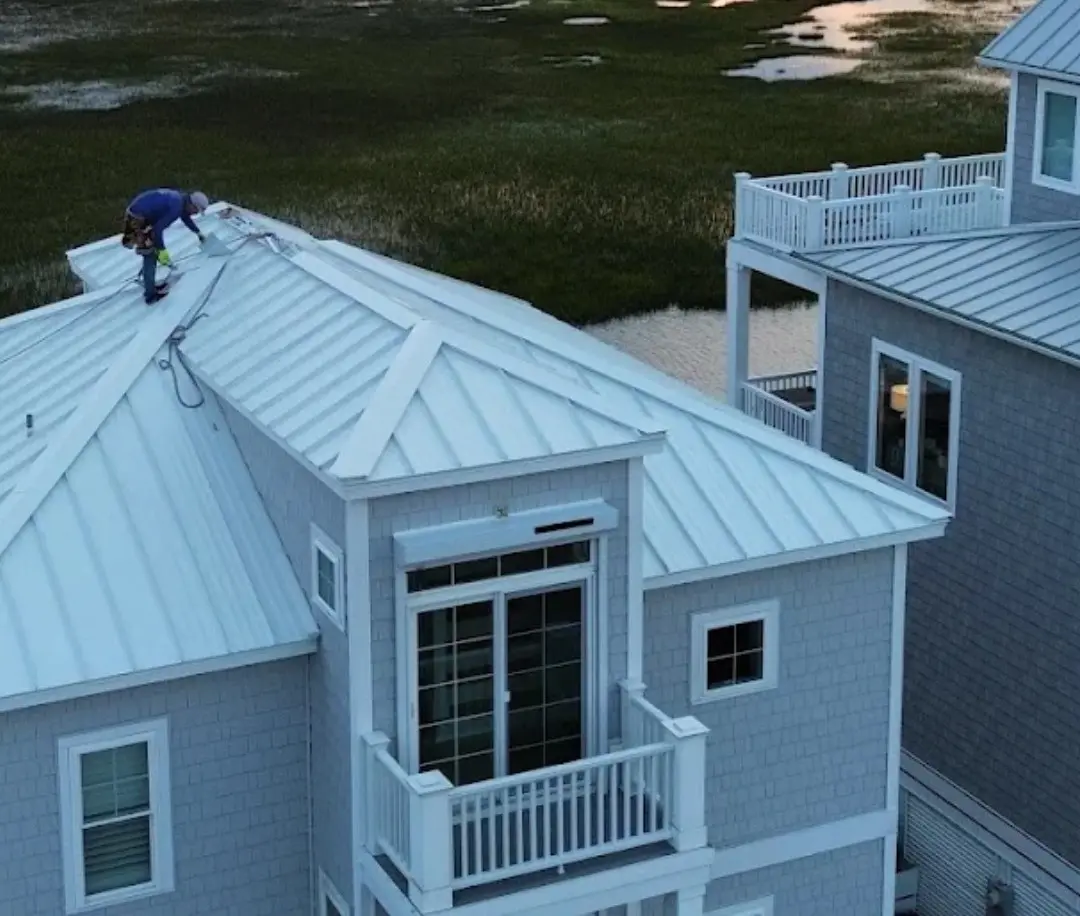 Summit Roofing team working on a metal roof