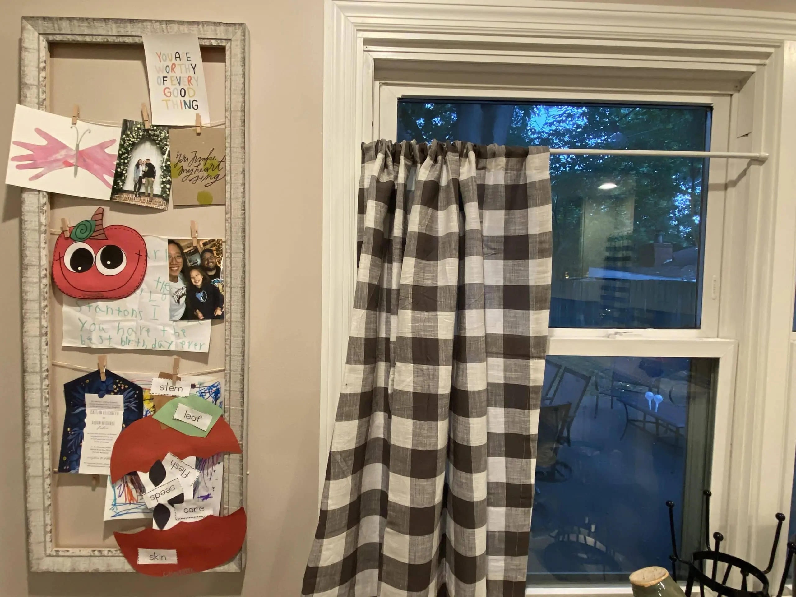 Picture frame with pictures and artwork clipped to yarn