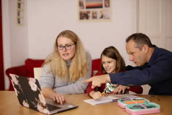 parents doing school work with daughter
