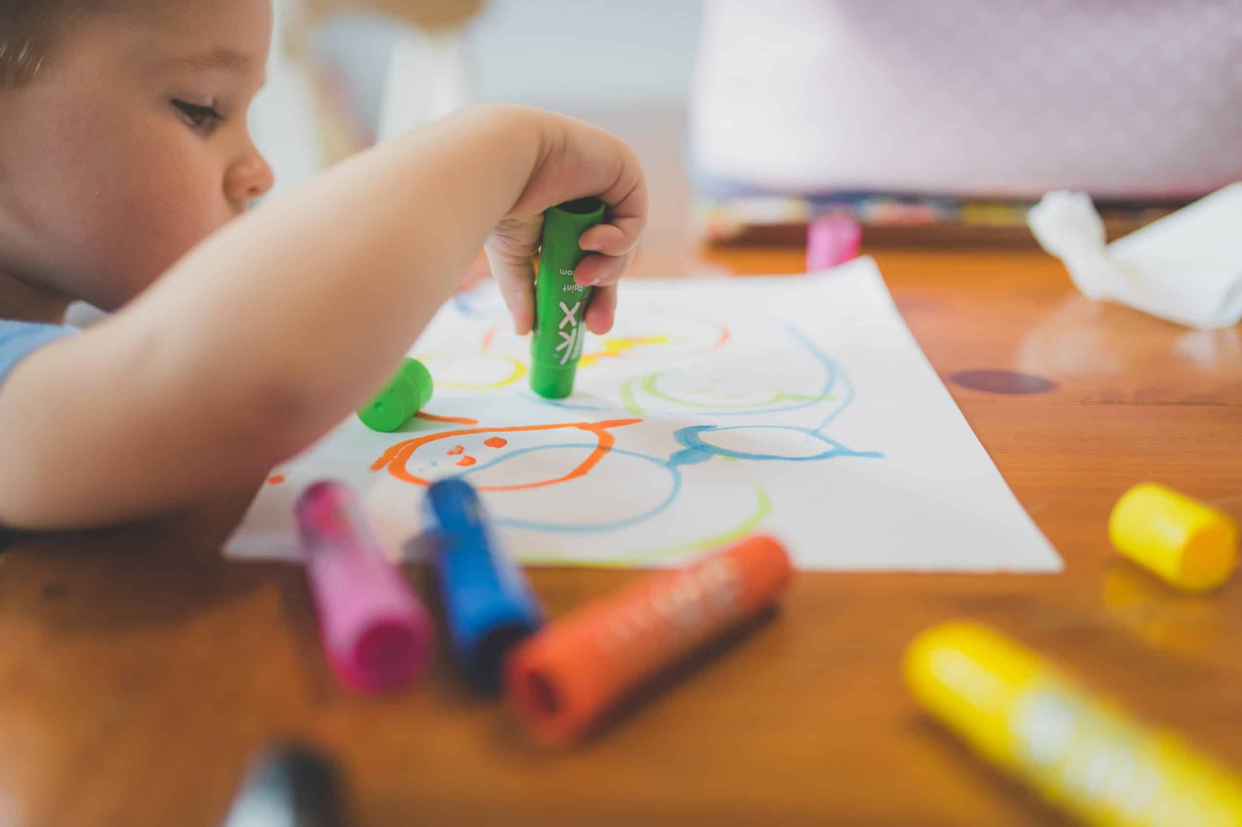 Child drawing on white paper