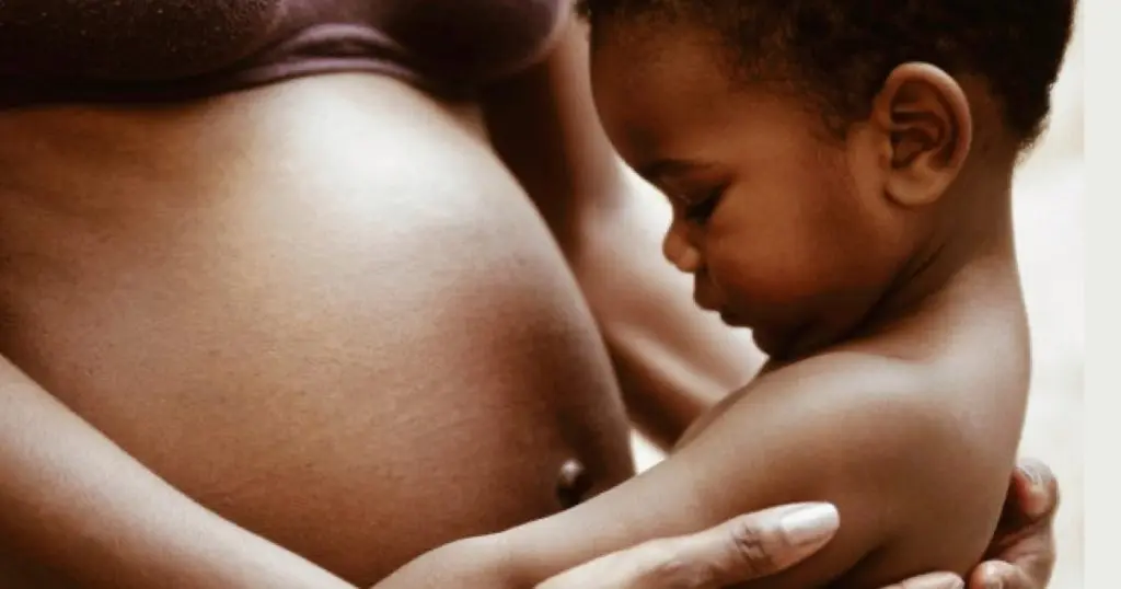 woman holding baby OBGYN guide