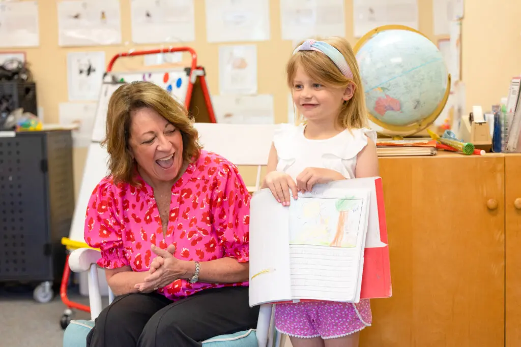 girl reading in front of her class