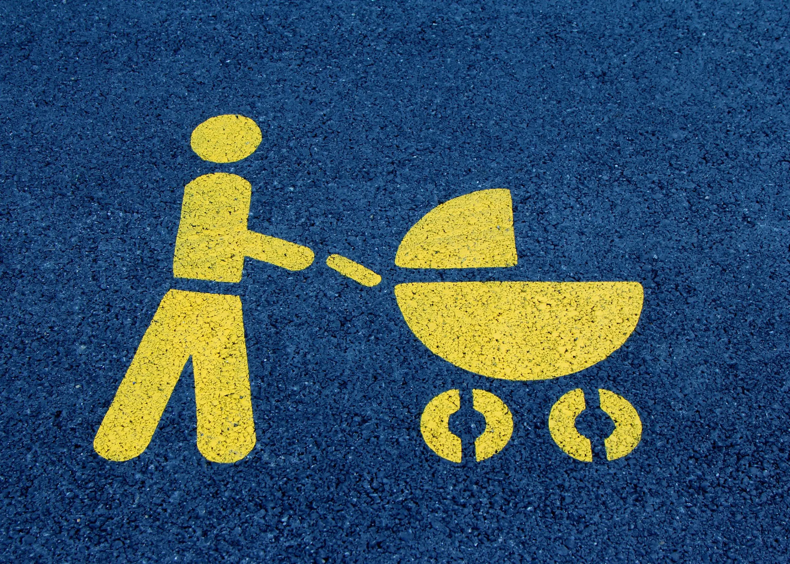 Painted street icon of person pushing a stroller
