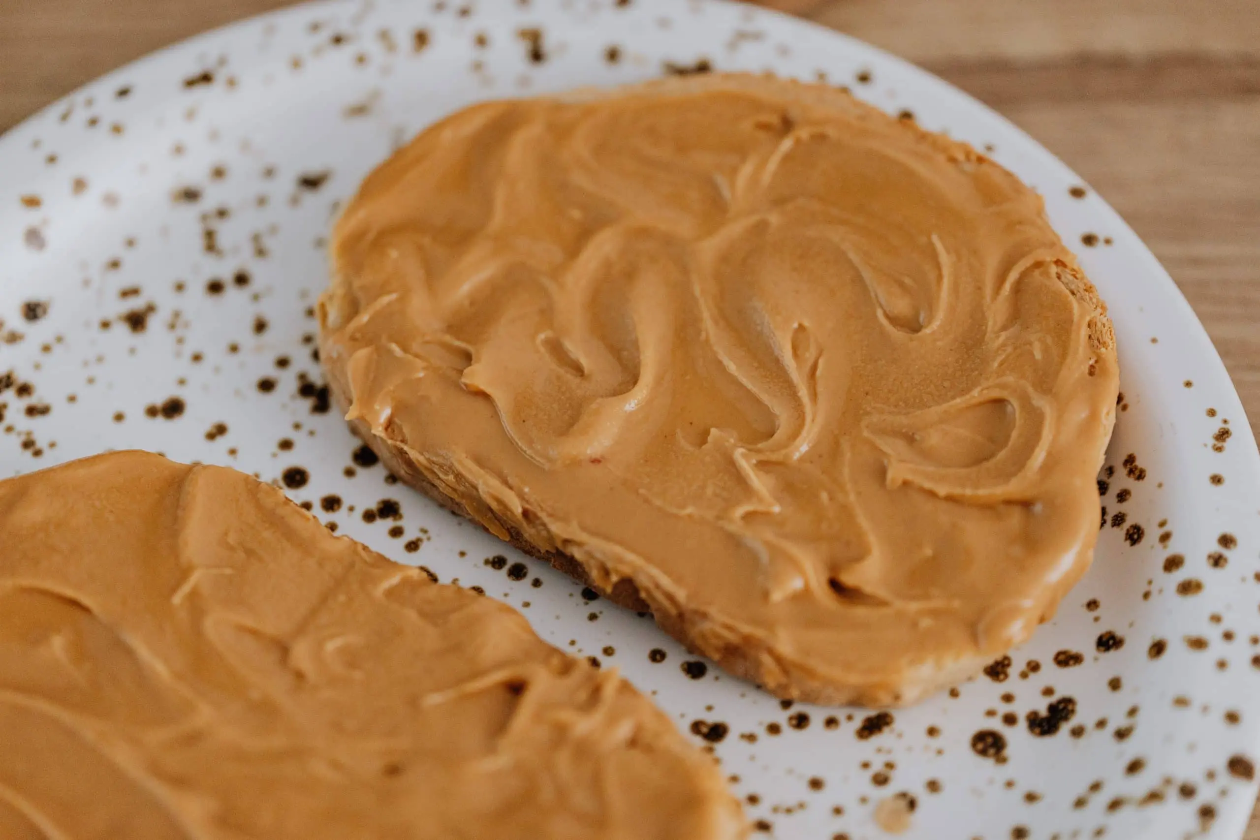 Picture of two pieces of bread with peanut butter containing xylitol on them.