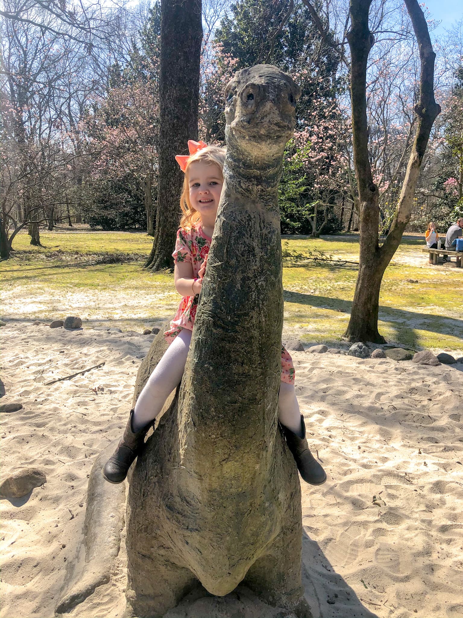 a dinosaur statue outside at the Botanic Garden