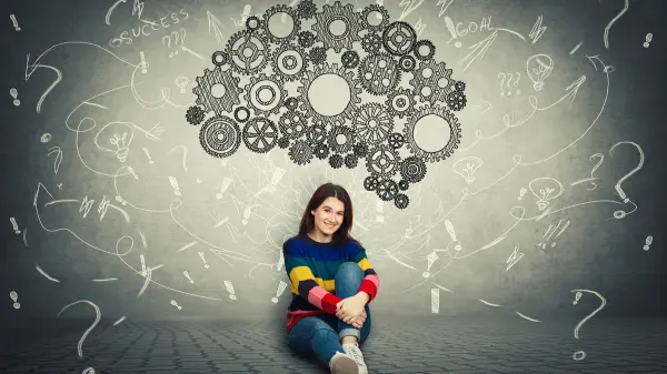 woman sitting under a graphic of brain
