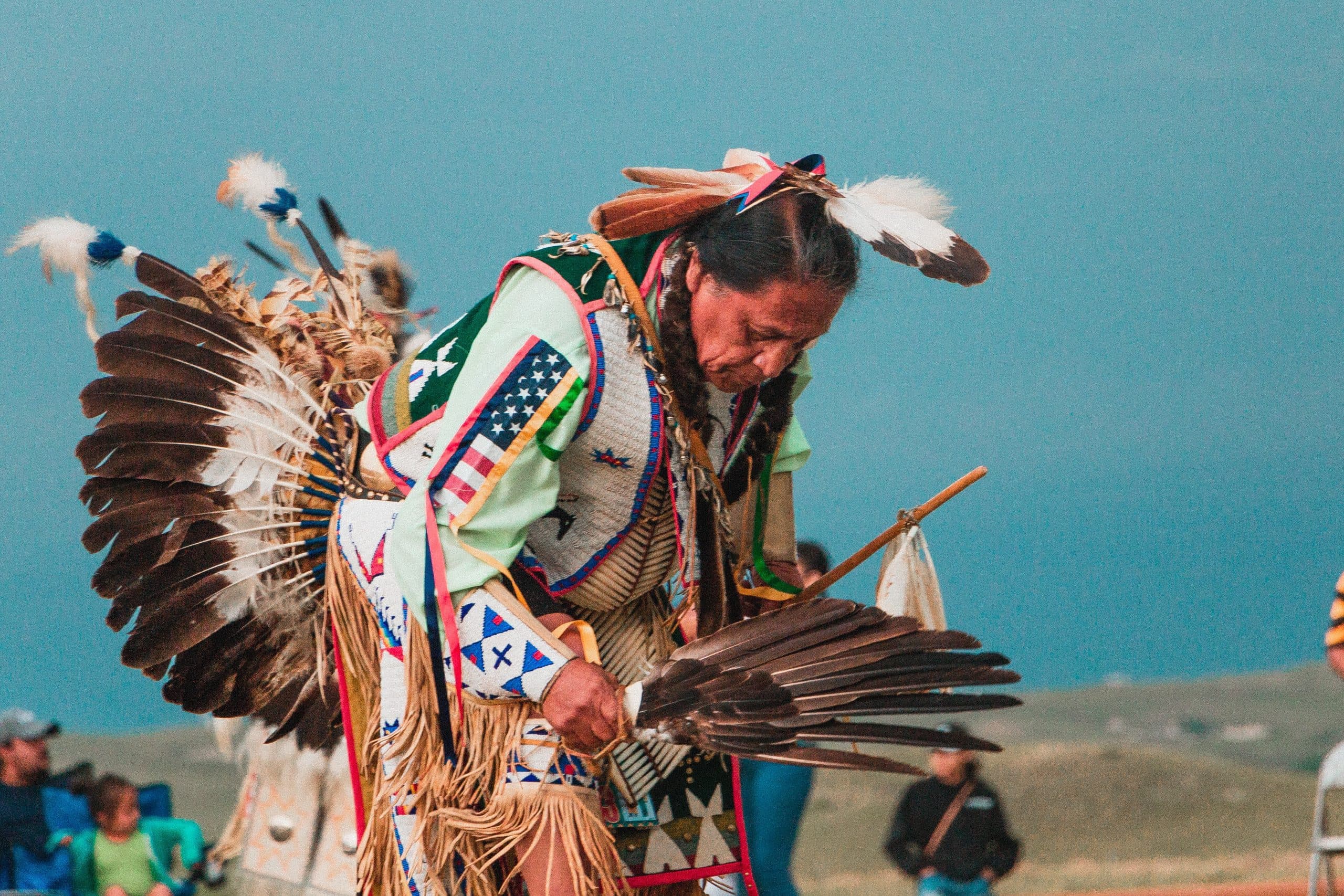 Indigenous person in ceremonial clothing dancing