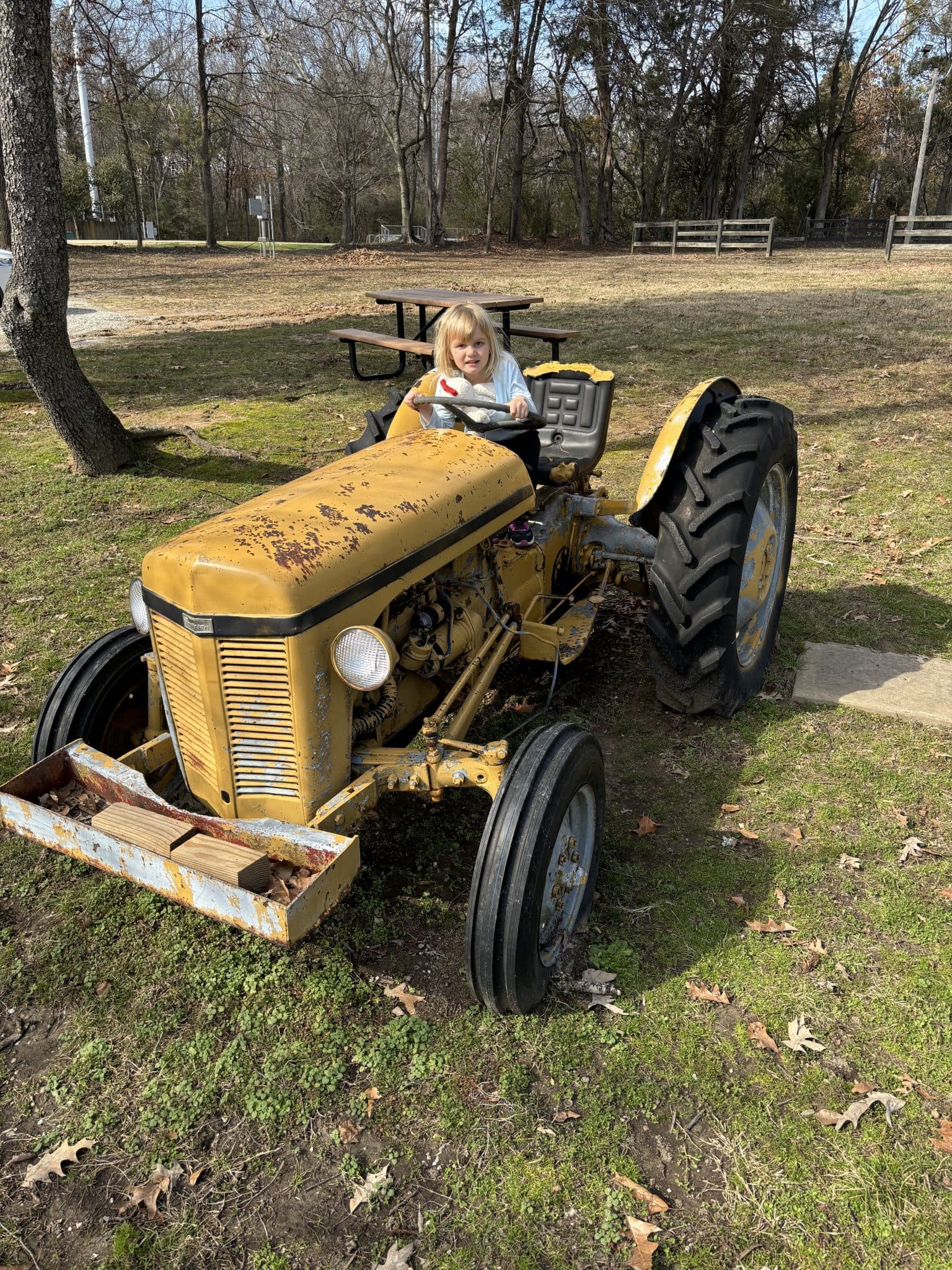 Girl on a yellow tractor