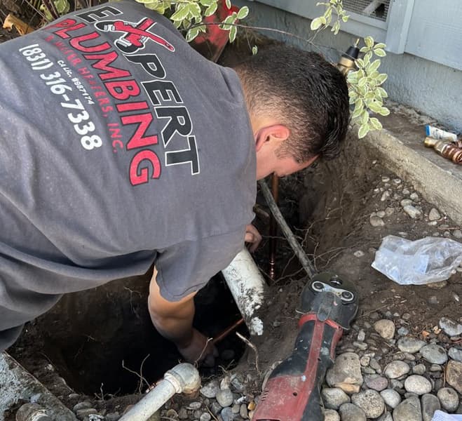 An emergency plumber providing urgent underground plumbing repair and specialized excavation services to resolve a critical water line issue.