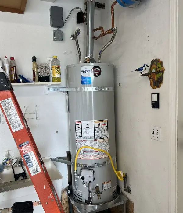 Technician replacing an old water heater with a new energy-efficient unit | Water Heater Installation & Replacements