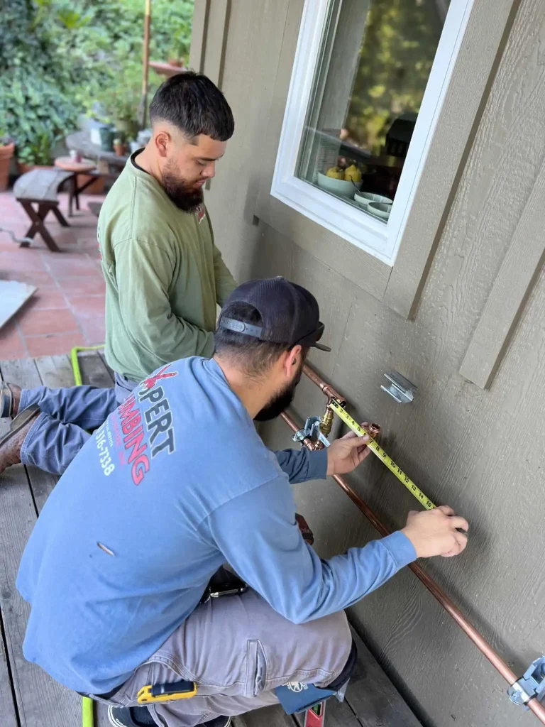 Expert Plumbing repiping services plumber Santa Cruz CA measuring pipes for whole home plumbing replacement and system upgrades