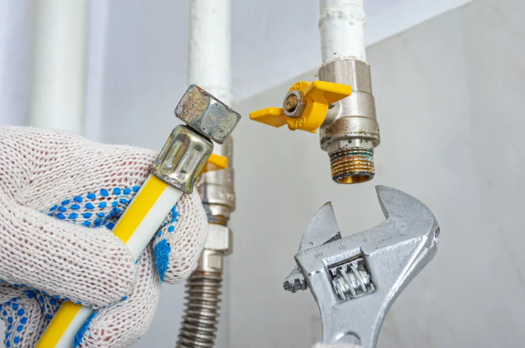 An emergency plumber expertly repairing damaged gas pipes and restoring a safe plumbing system during an urgent service call.