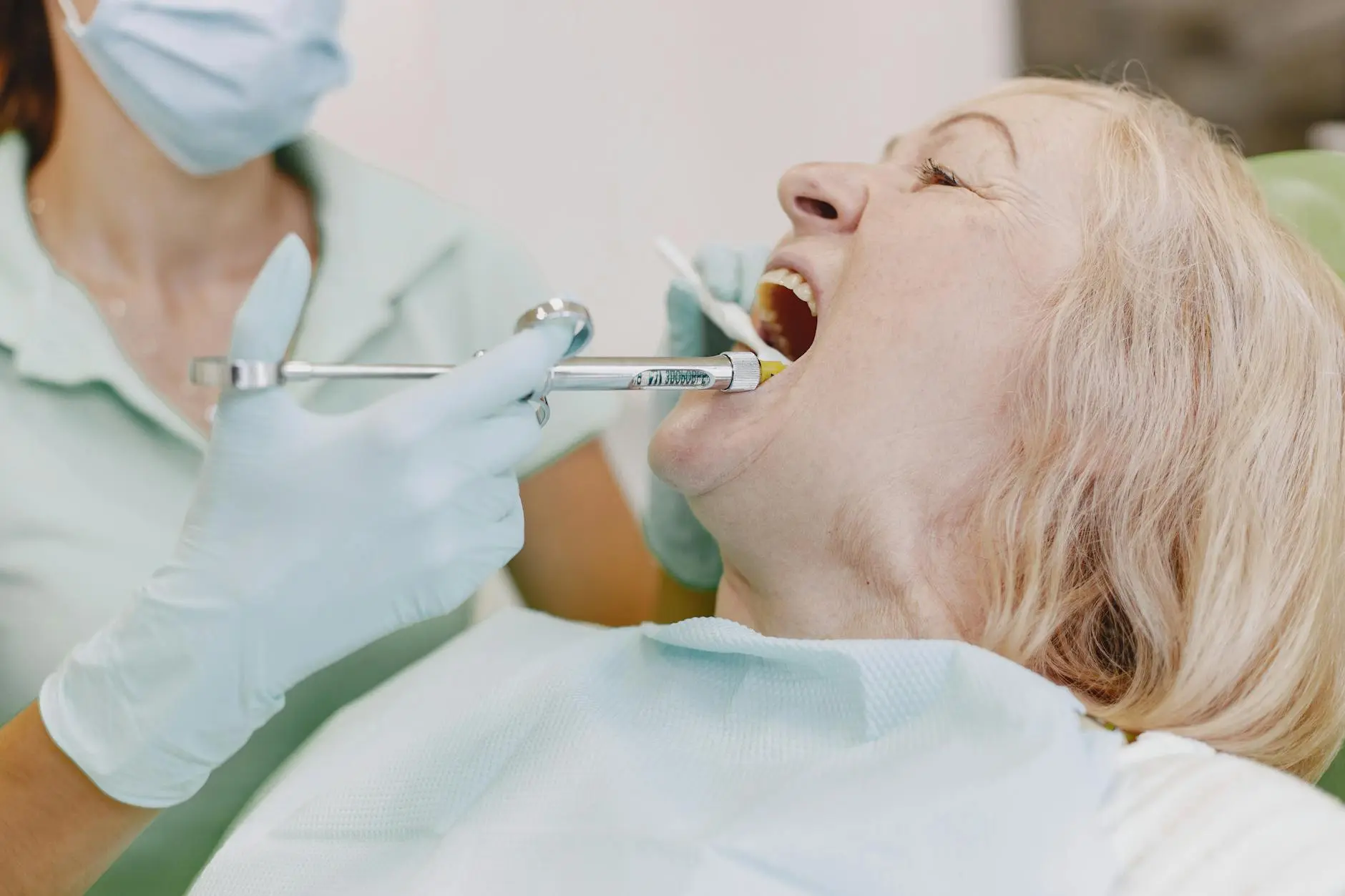 an elderly woman having her dental check up