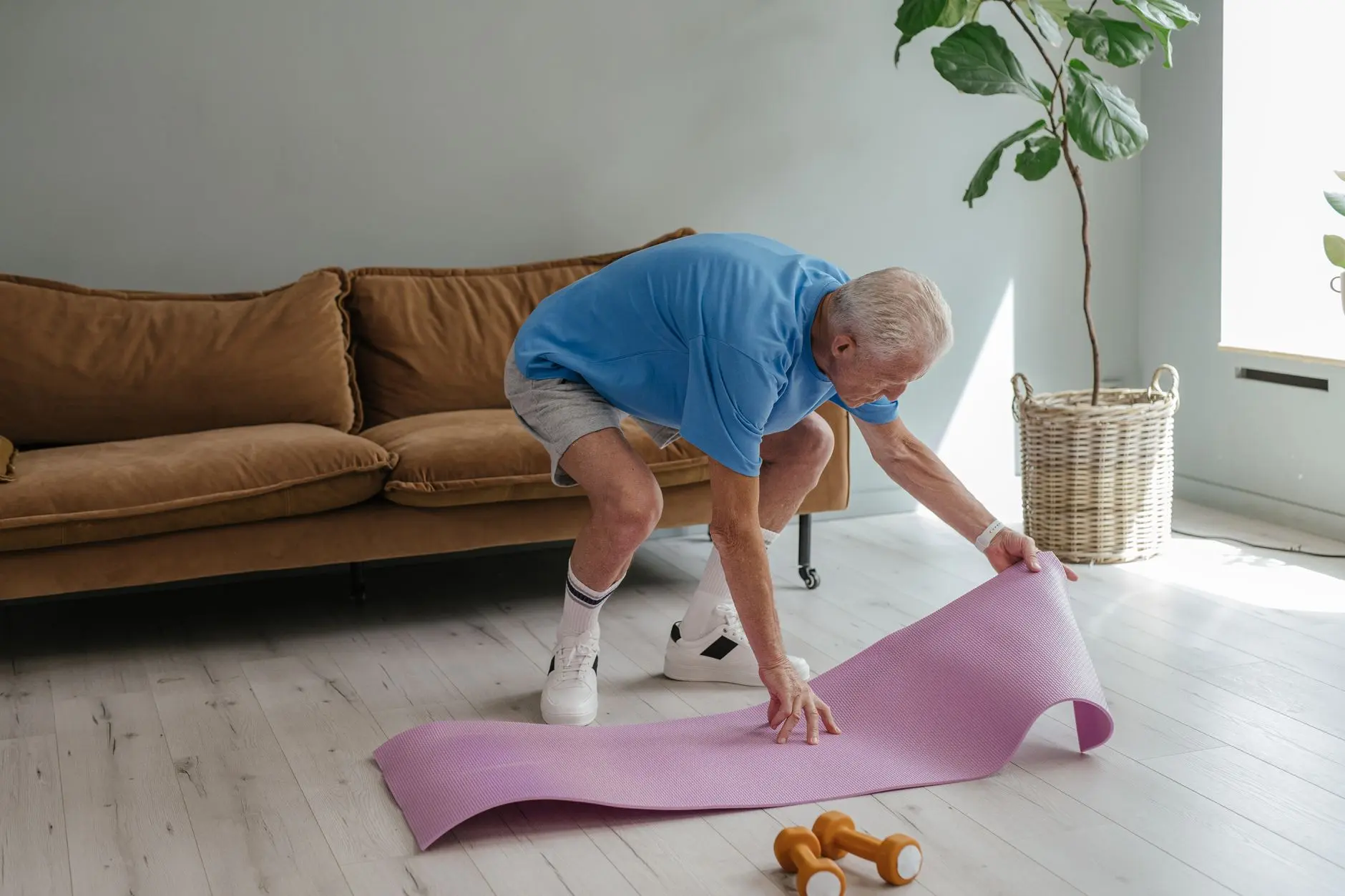a man setting up his yoga mat