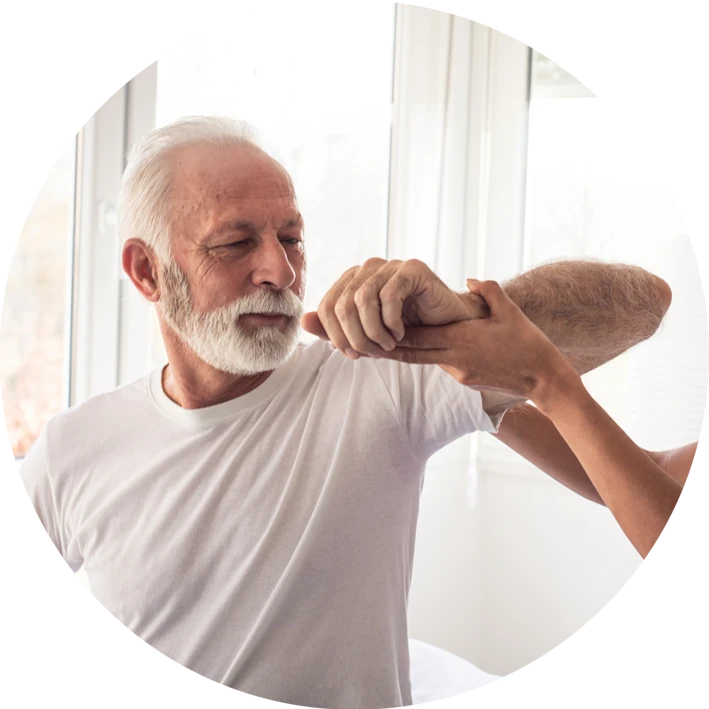 elderly man stretching his arm with help of a nurse