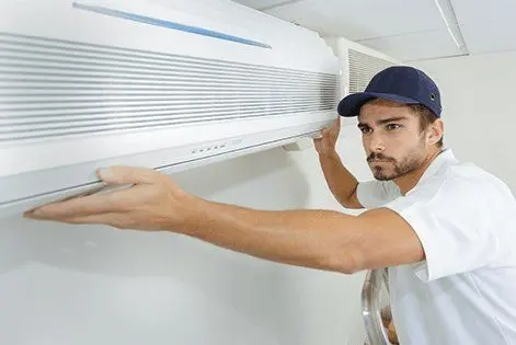 HVAC techinician fixing an AC unit