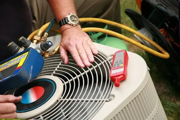AC Repair technician inspecting an external AC unit