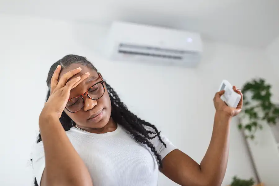 Woman facing AC unit not working