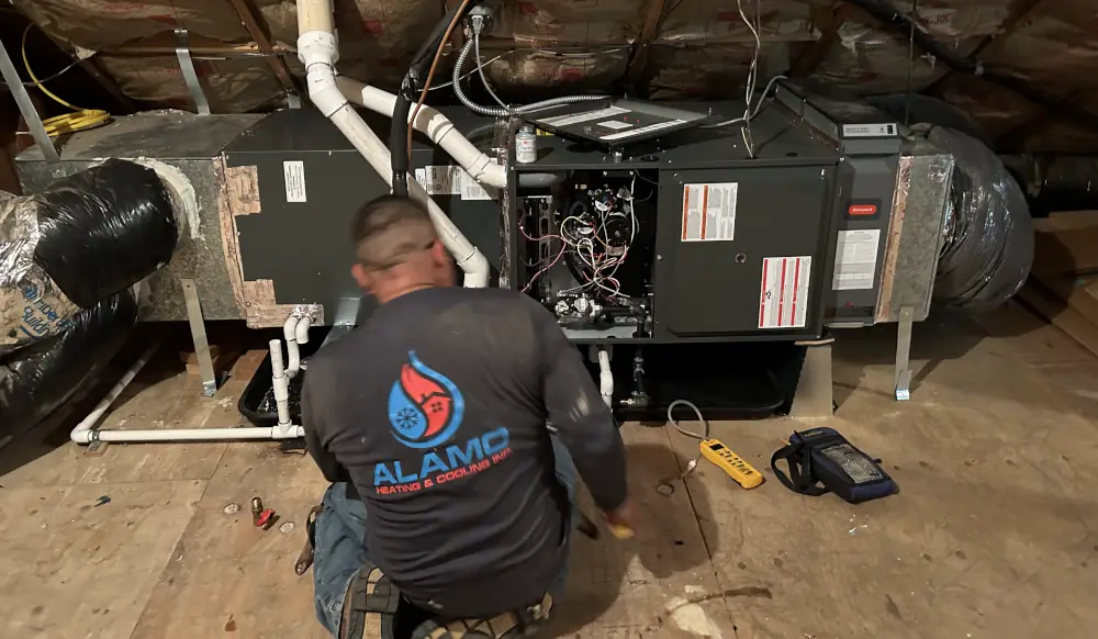 Furnace inspection and maintenance cost - Alamo HVAC technician inspecting a furnace