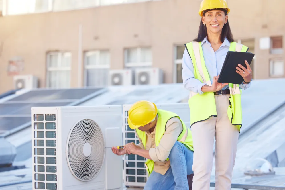 Air conditioner, building maintenance and teamwork with tablet, smile and development with engineer