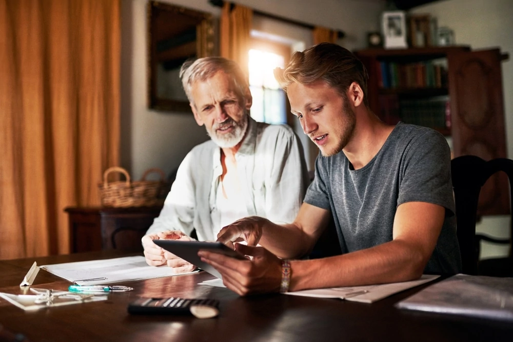 Two men looking at financing options in a tablet