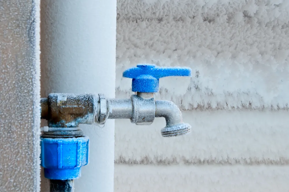 Why spring warmth is worse for pipes than winter freeze - Picture of a frozen spigot.