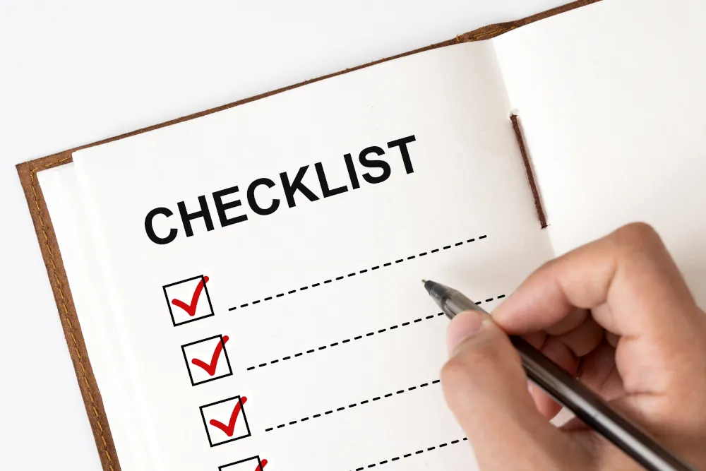 Checklist marked red with a pen, spring plumbing checklist