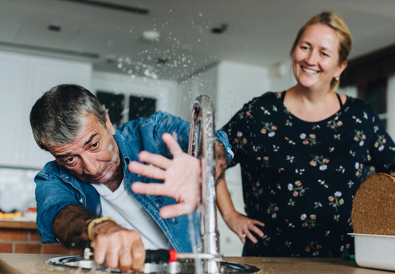 Couple fixing a kitchen sink