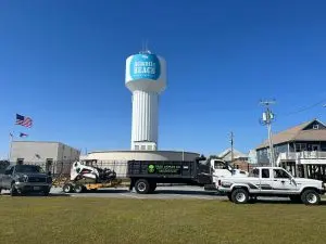 Tree Works LLC trucks and equipment in front of the Atlantic Beach water tower in Chesapeake, VA.