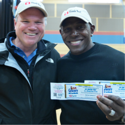 gThankYou’s David Irwin with NFL Legend Donald Driver distributing certificates at the Journey House