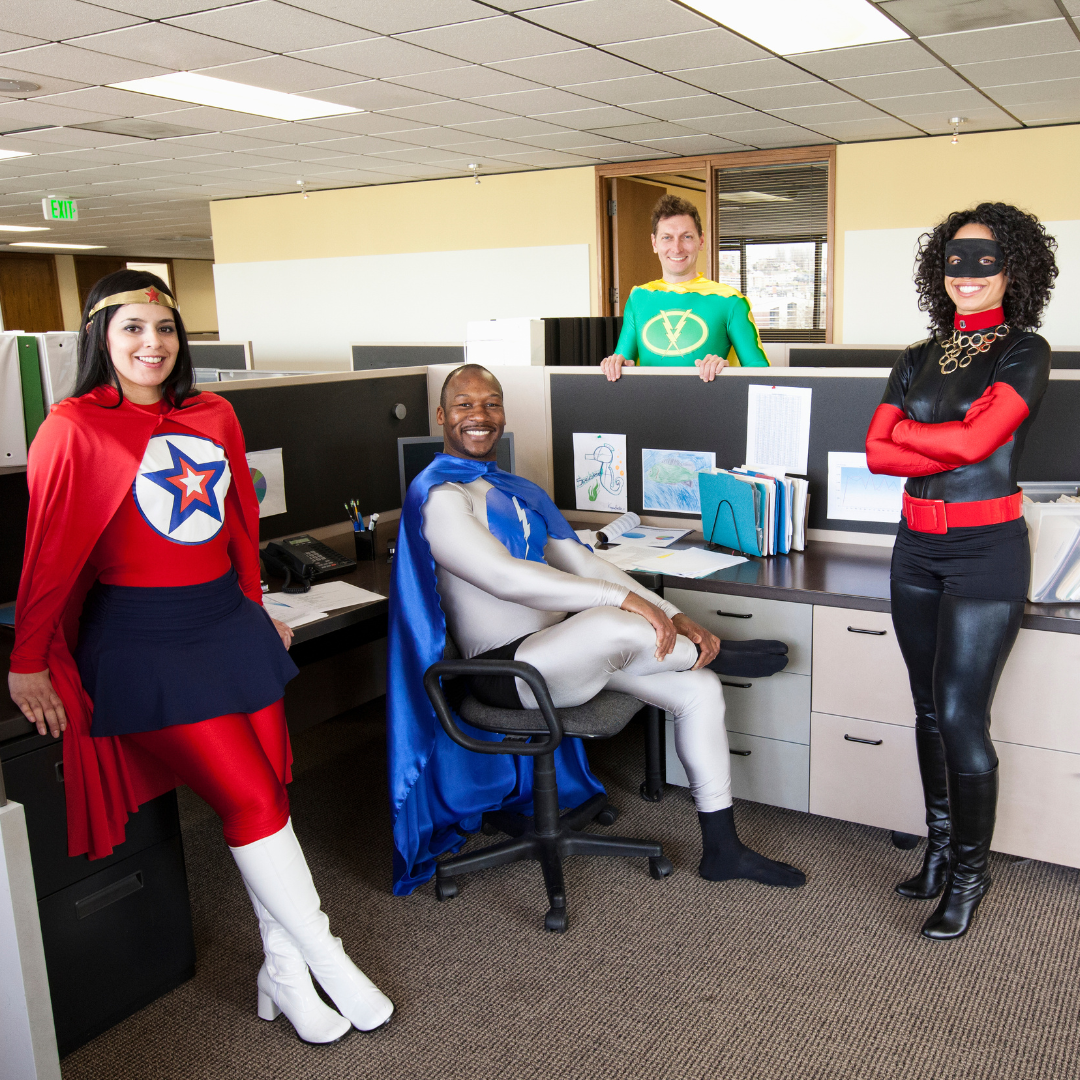 Employees celebrating Halloween at work with costumes and decorations