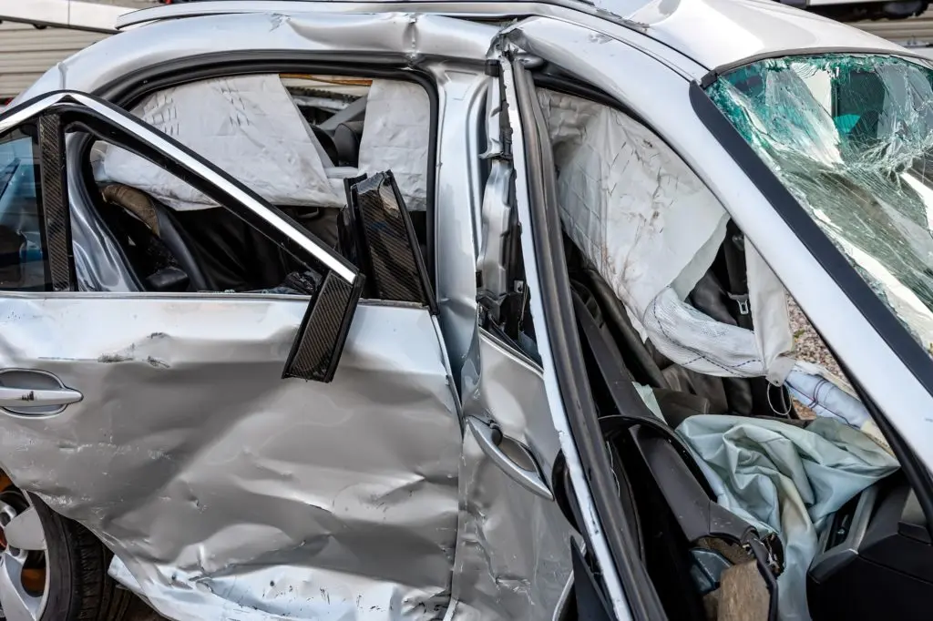 damaged vehicle closeup after a heavy crash, traffic accident, insurance concept