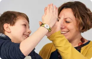 Lady and young person giving high five