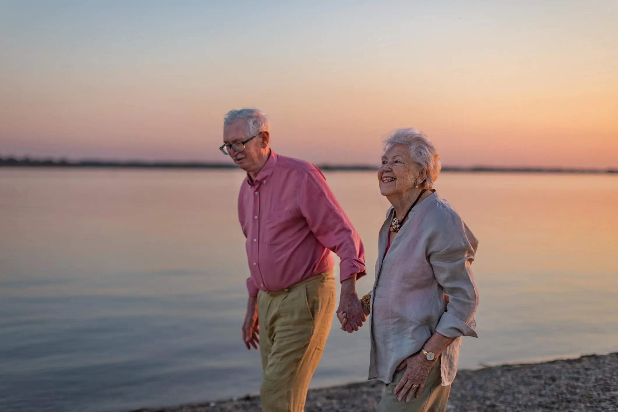 Senior Citizen couple walking along beach
