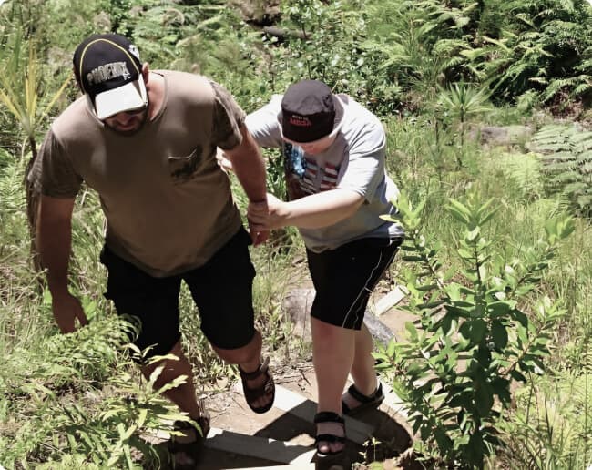 person with autism on bush walk with family image