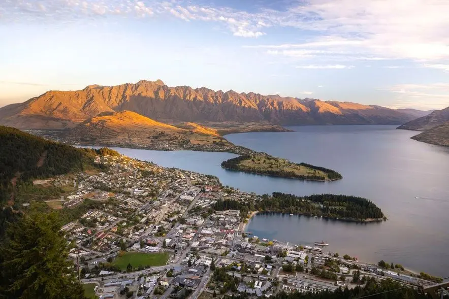Queenstown and Lake Wakatipu from above, with The Remarkables at sunset