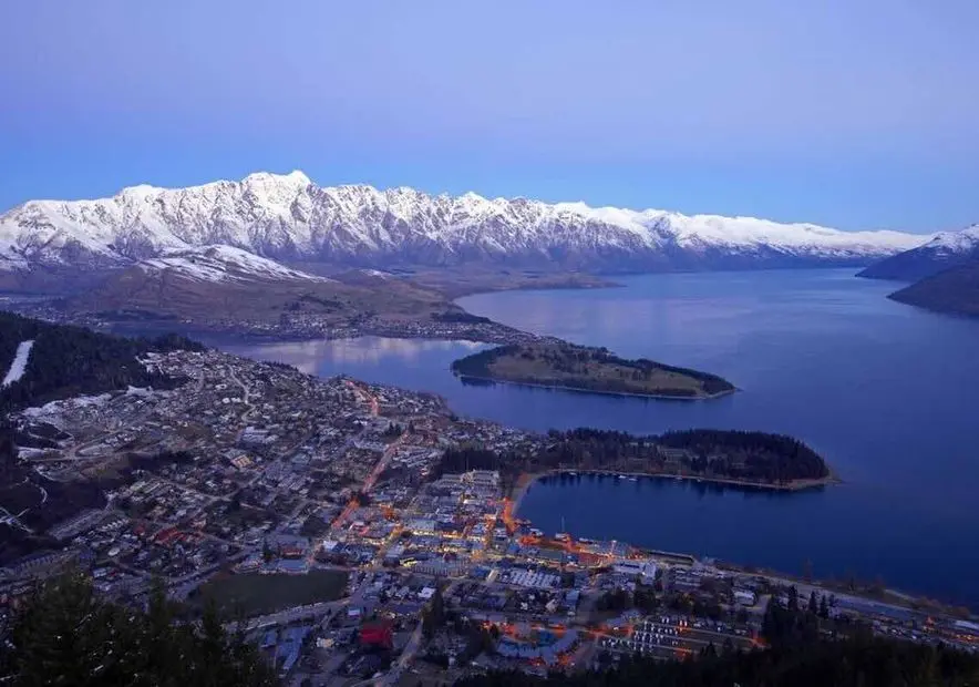 Queenstown and Lake Wakatipu at dusk, with snow on The Remarkables