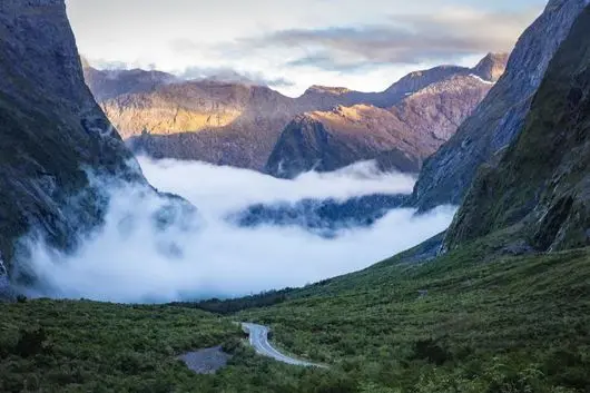 Low cloud filling the valley below mountains on the Milford Road