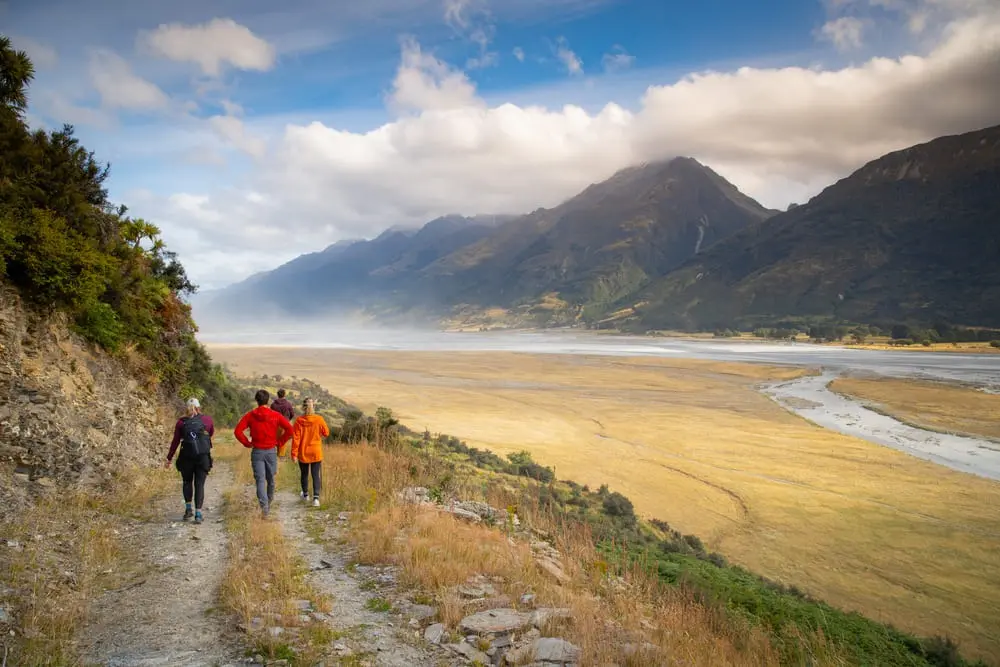 Guests walking the Mt Alfred Terraces track above a braided river valley