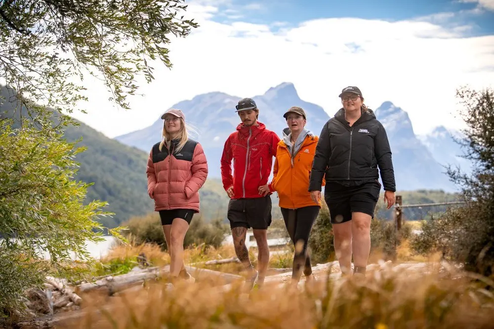 Guide and guests walking on a wooden bridge near Diamond Lake