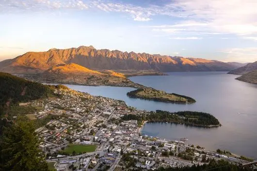 Queenstown and Lake Wakatipu from above, with The Remarkables at sunset