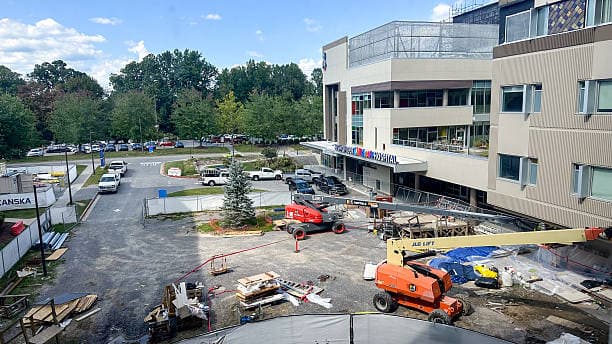 Construction crew using a boom lift during a hospital seismic retrofit project.