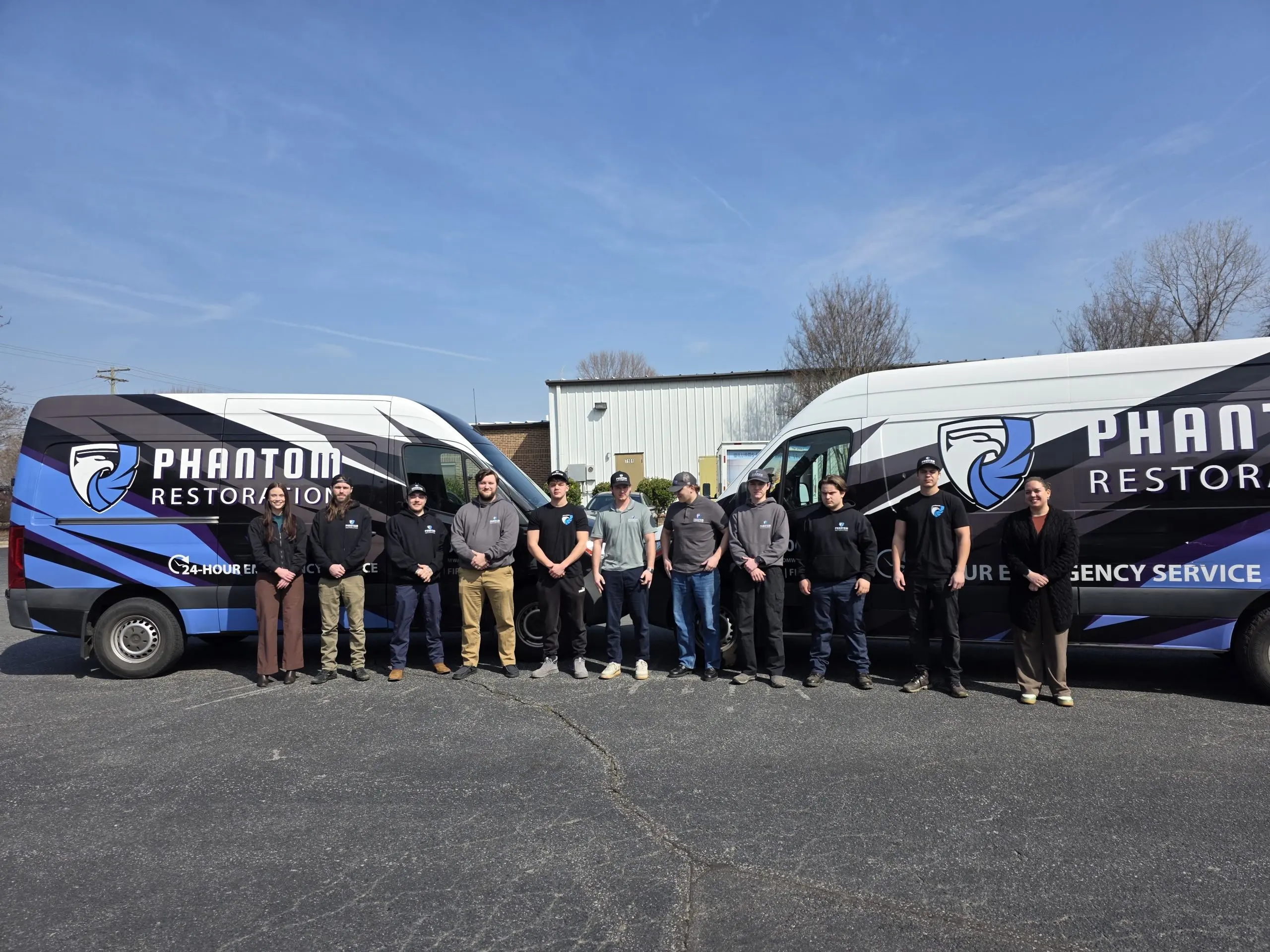 Phantom Restoration Company Members Standing all together in Group infront of their Company Wagons