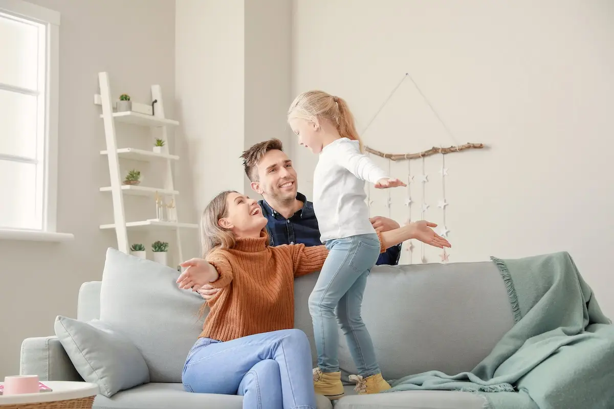 Portrait of happy young family at home