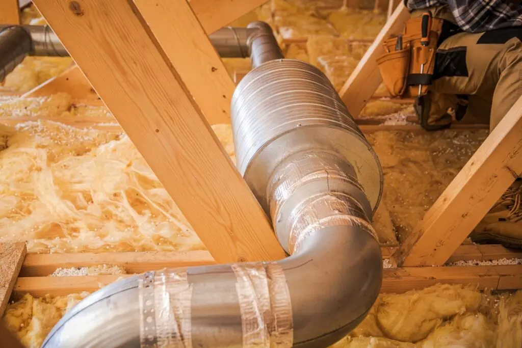 Installation of Ductwork in Residential Attic During Home Renovation Process