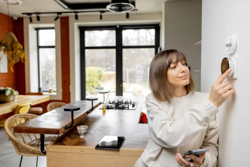 thermostat wiring woman adjusting temperature inside big comfortable home