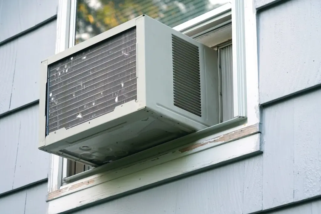 old air conditioner installed on house window
